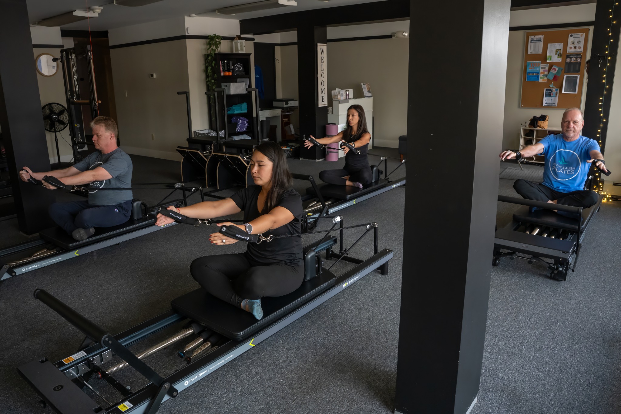 Clients practicing reformer Pilates at Revive & Align